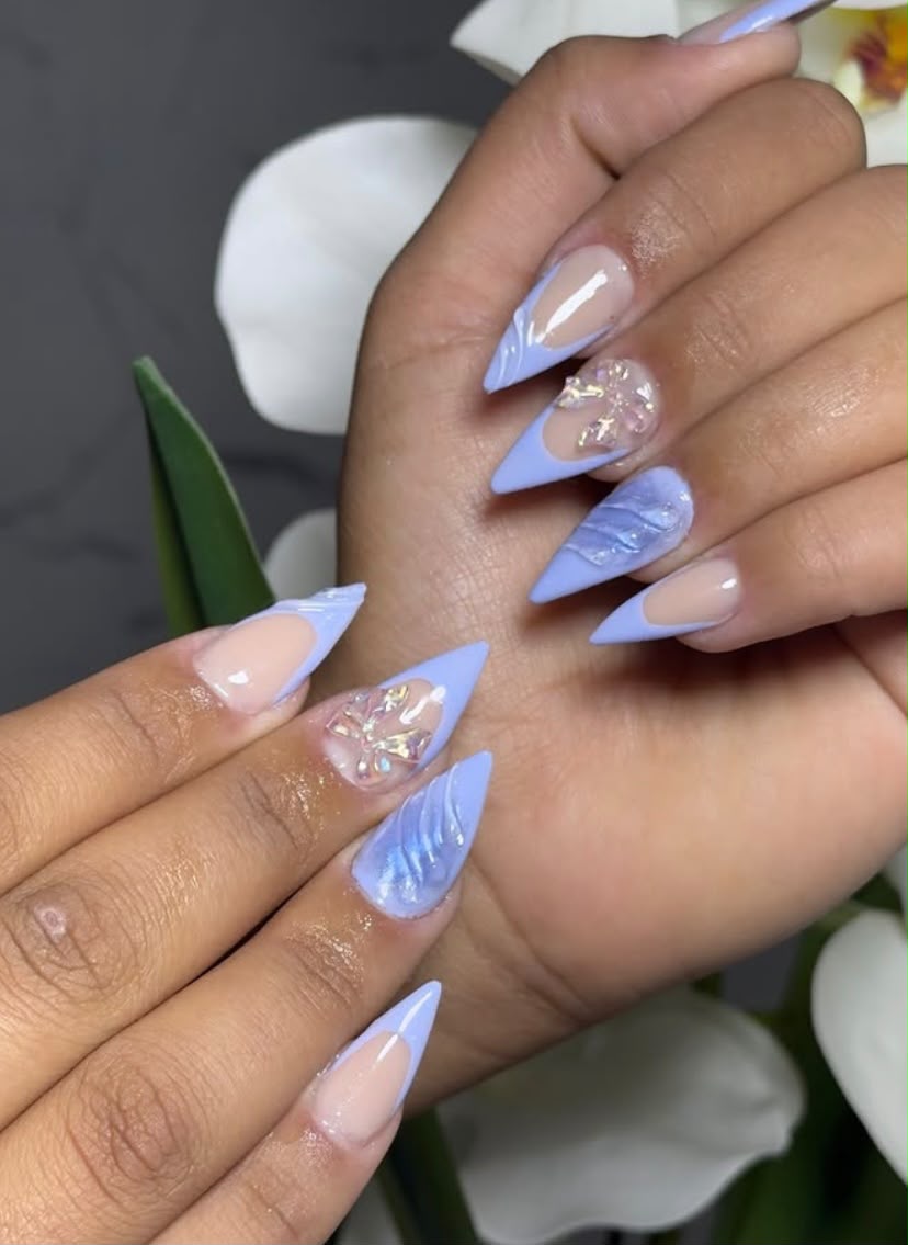 Unhas stiletto azuis com aplicações